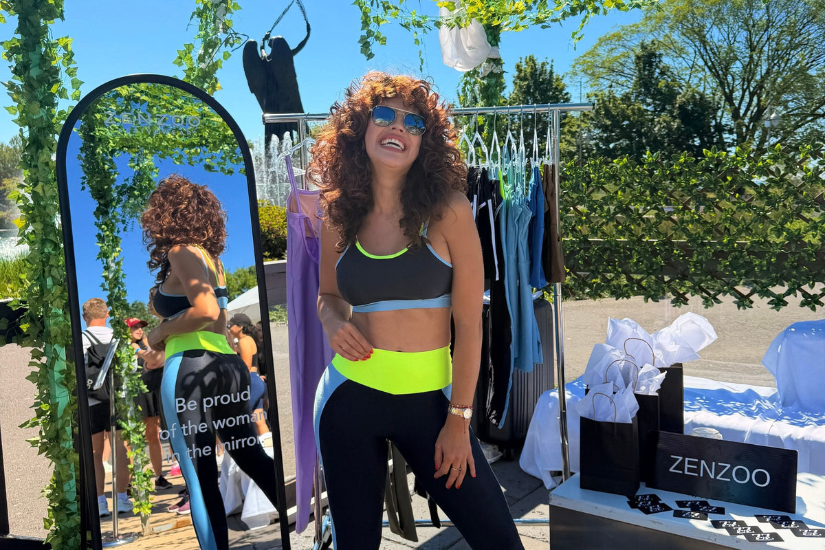Woman laughing beside the Zenzoo mirror display at the Toronto pop-up event